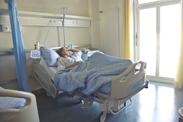 An adult unwell in a hospital bed